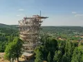 Drewniana wieża Sky Walk wznosi się ponad zielonym lasem, oferując zapierające dech w piersiach widoki na okolicę i miasteczko.